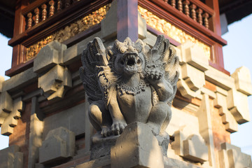 Bali statue on a tower in front of temple