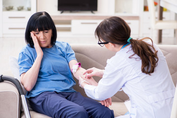 Doctor making injection to senior old woman