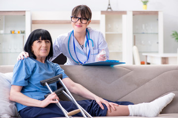 Fototapeta premium Doctor examining old mature woman after incident