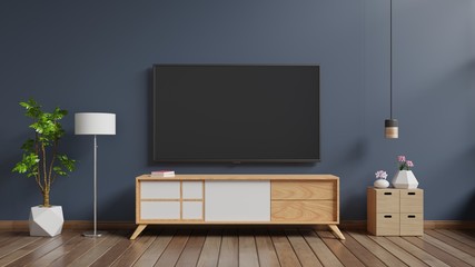 TV on cabinet in modern living room with lamp,table,flower and plant on dark wall background,3d rendering