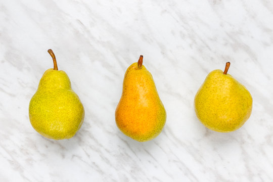 Ripe pears on marble background
