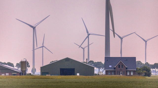 Modern farm in open countryside with wind turbines