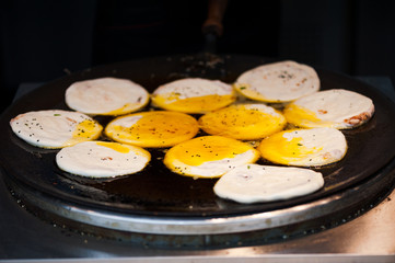 Guoqui chinese pancake cooked with oil in a stove, China