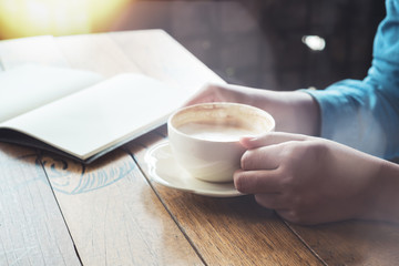 Young business women break time in cafe with hot coffee cup. vintage film effect