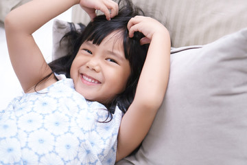 Asian children cute or kid girl cheerful wake up in morning or sleeping and open eye with white...