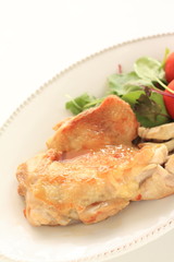 Chicken sauteed served with tomato and baby leaf