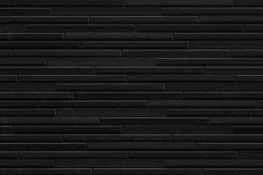Modern black stone tile wall pattern and seamless background