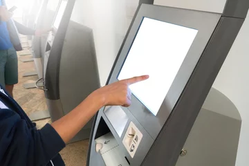 Deurstickers Asian boy check-in by using kiosk self check-in machines in Terminal at International Airport. © wittayayut
