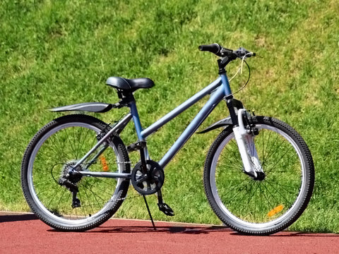 New blue women's bike on a grass background