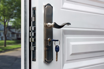 Open door of a family home. Close-up of the lock with your keys on an armored door. Security. - obrazy, fototapety, plakaty
