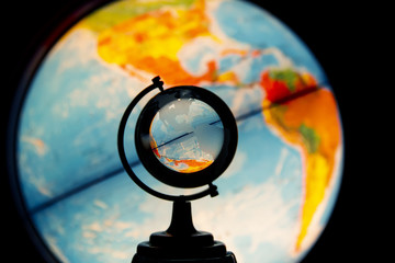 Luminous desktop globe, view oh North and South Americas through small transparent glass globe - obrazy, fototapety, plakaty
