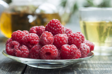 Raspberry and green tea from a linden on a wooden table