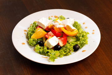 Greek salad on white table