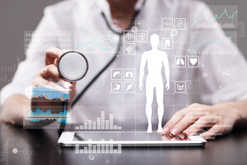 Doctor using modern computer with Medical record diagram on virtual screen concept. Health monitoring application.