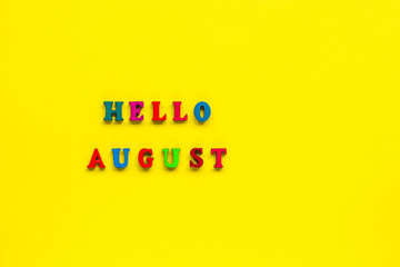 Text Hello August from colorful letters, yellow background