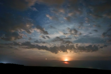 Night sky view with shining stars and the clouds