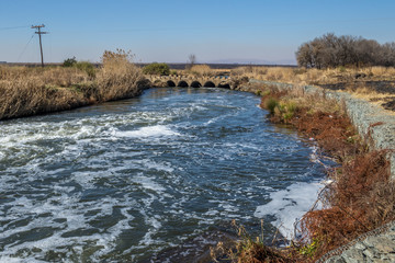Old low water concrete bridge with a modern gabion retaining wall to control erosion image with copy space in landscape format