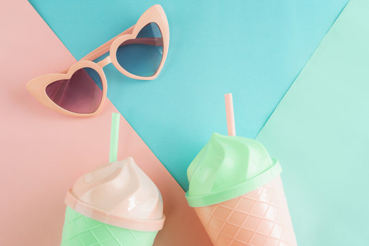 Fancy glass with heart shape sunglasses on pastel colors background, Summer concept
