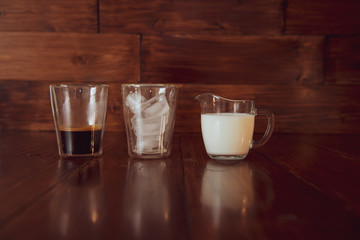 three ingredients for coffee with ice are spread out over cups
