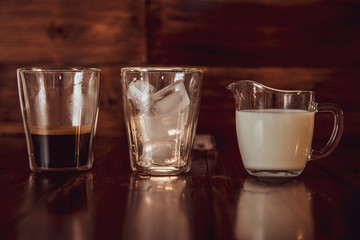 three ingredients for coffee with ice are spread out over cups