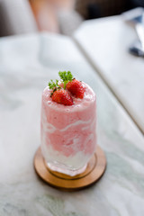 strawberry milkshake on stone table, ingredient of strawberry, milk, ice and yogurt