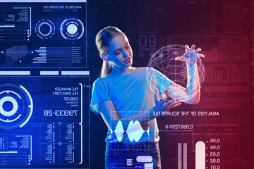 Creating Earth hologram. Clever young person feeling interested while standing with a realistic...