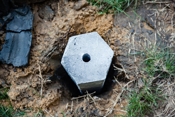 Group of foundation concrete pile put into the ground as structure base in house construction site.