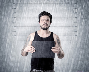Gangster with rainy, lowering background and table on his hand.