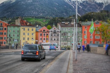 Scenic European road with colorful buildings and hills in the background