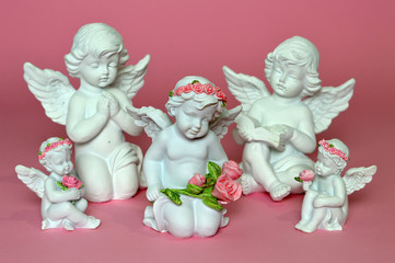 Group of little angels on pink background
