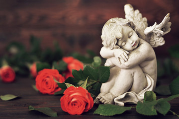 Condolence card with an angel and funeral roses on dark background