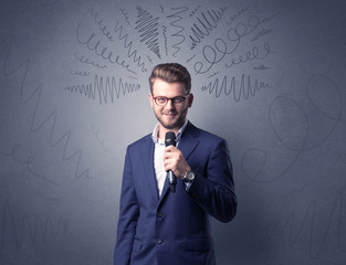Businessman speaking into microphone with scribbles over his head 