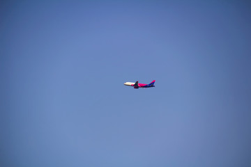 Passenger plane from side on blue sky, copy space
