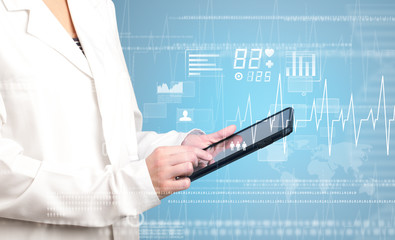 Female doctor holding tablet with blue background and heart related charts 