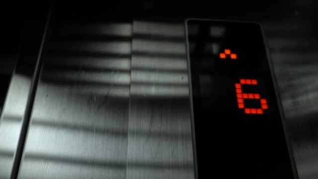 In elevator of modern business center on electronic LCD display. View of the panel with the number and steel silver lining. The monitor shows the number four, five, six, 4, 5, 6.