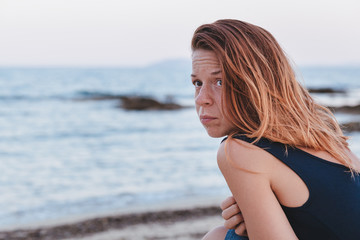 Woman alone and depressed sitting at the beach