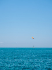 The paratrooper is flying over the sea
