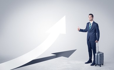Obraz premium Young businessman hitchhiking with progressive arrow concept and copyspace 