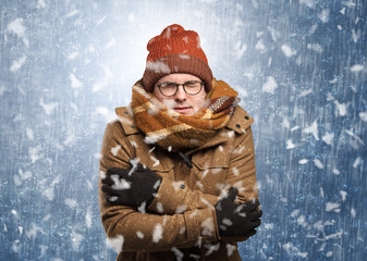 Handsome young boy shivering and trembling at snowstorm concept
