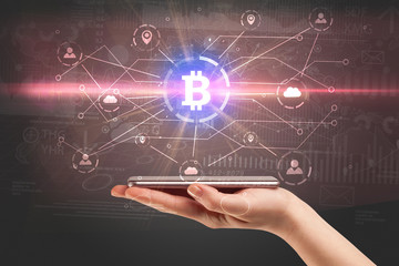 Naklejka premium Hand using phone with cryptocurrency bitcoin link network and online concept 