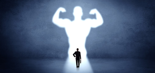 Businessman standing and dreaming about a strong superhero