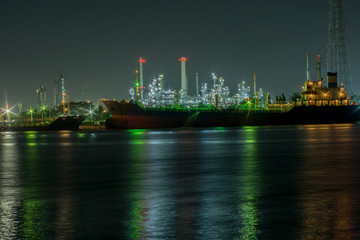 Power plant with shipping boat at night time