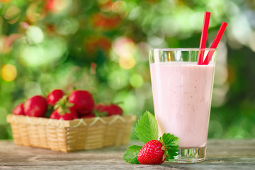 strawberry milkshake in glass on table