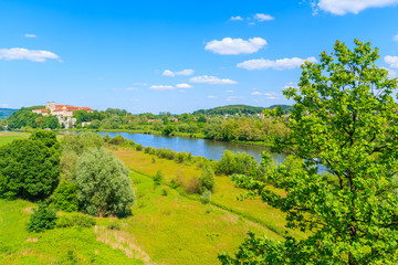 Fototapeta na wymiar View of Tyniec monastery and green fields along Vistula river on sunny spring day, Cracow city, Poland