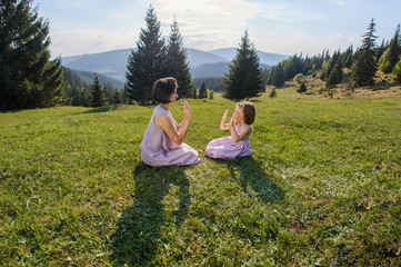 Mother and Daughter Playing on Meadow