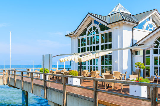 Fototapeta View of pier with historic building built above sea on beach in Ostseebad Sellin, Baltic Sea, Germany