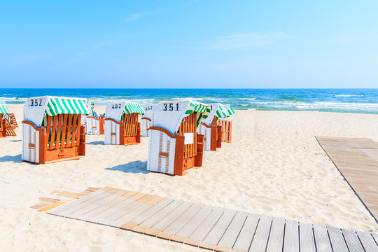 Traditional wicker chairs on sandy beach in Baabe town, Ruegen island, Baltic Sea, Germany