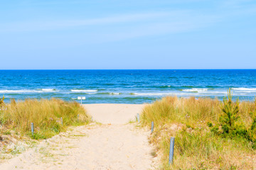 Fototapeta na wymiar Path to beach in Baabe summer resort among sand dunes, Ruegen island, Baltic Sea, Germany