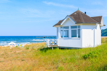 Fototapeta na wymiar Lifeguard booth on beach in Goehren summer resort among sand dunes, Ruegen island, Baltic Sea, Germany