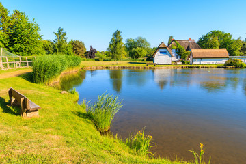 Obraz premium Typical houses with straw roofs on lake shore near Goehren village, Ruegen island, Baltic Sea, Germany